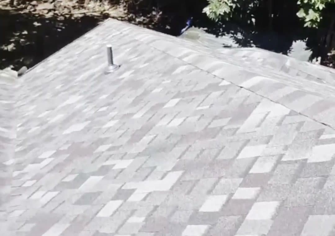 A shingle roof plane running up to the ridge with a pipe boot vent, on a completed Sobczak Exteriors job