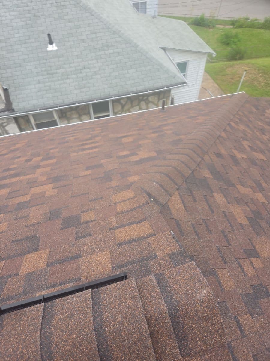 Capped ridge and new terracotta shingle courses beside the neighbouring roofline